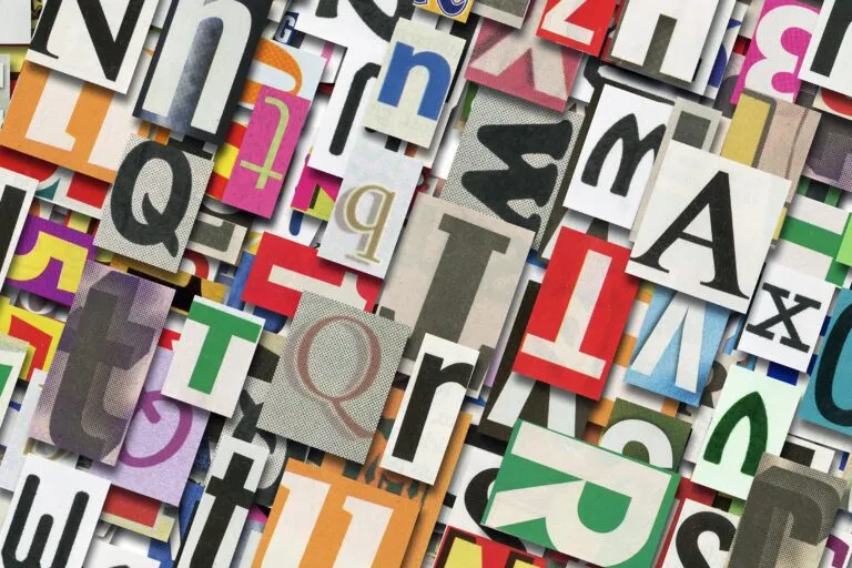 An assortment of different fonts in different colours and styles, cut-out from newspapers and magasines